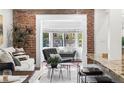 Cozy living room featuring exposed brick and comfortable seating near the sun room at 1832 W 36Th Ave, Denver, CO 80211