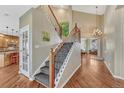 Elegant staircase with wooden banister and view of the foyer at 9315 E Aspen Hill Ln, Lone Tree, CO 80124