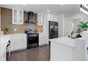 Well-lit kitchen with sleek black stainless steel appliances and stylish backsplash at 730 W Elmhurst Pl, Broomfield, CO 80020