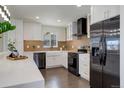 Bright kitchen with stainless steel appliances, a farmhouse sink, and attractive backsplash at 730 W Elmhurst Pl, Broomfield, CO 80020