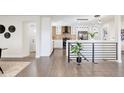 Open concept living space featuring modern railing and views of the updated kitchen at 730 W Elmhurst Pl, Broomfield, CO 80020