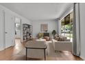 Inviting living room with wood floors, neutral furniture, natural light, and open floor plan at 4155 S Lipan St, Englewood, CO 80110