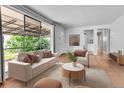 Bright living room with neutral decor, wood floors, large windows, and open floor plan at 4155 S Lipan St, Englewood, CO 80110