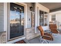 Inviting front porch with seating area, decorative wreath, and a welcoming atmosphere at 11866 High Desert Rd, Parker, CO 80134