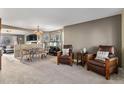 Cozy living room featuring comfortable seating, neutral carpet, and an open layout at 11866 High Desert Rd, Parker, CO 80134