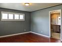 Cozy living room featuring hardwood floors, neutral wall colors, and ample natural light at 1500 S Perry St, Denver, CO 80219