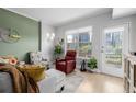 Bright living room featuring a city view from the windows, seating, and stylish decor at 1975 N Grant St # 509, Denver, CO 80203