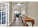 Inviting hallway with wood floors, leading to a living room with a vaulted ceiling and natural light at 17216 E Trailmaster Dr, Parker, CO 80134