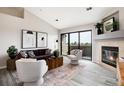 Open-concept living area with a fireplace and access to the outside through a sliding glass door at 7408 S Alkire St # 301, Littleton, CO 80127