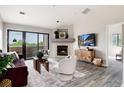Bright living room featuring a fireplace, balcony access, and stylish decor at 7408 S Alkire St # 301, Littleton, CO 80127