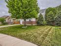 Charming two-story home with a well-manicured lawn and mature trees in a quiet neighborhood at 8010 Raspberry Dr, Frederick, CO 80504