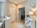 Welcoming foyer with neutral decor, a charming chest, and a view into the office at 8010 Raspberry Dr, Frederick, CO 80504