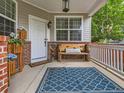 Inviting front porch with stylish decor, a comfortable bench, and a cozy welcome mat at 8010 Raspberry Dr, Frederick, CO 80504