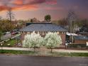Stunning exterior view of a brick home, showcasing its classic architectural details and beautiful landscaping at 201 S Lafayette St, Denver, CO 80209