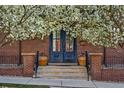 Inviting front entrance with double doors, brick pillars, and potted plants at 201 S Lafayette St, Denver, CO 80209