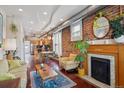 Open-concept living room with exposed brick wall, fireplace, and hardwood floors at 3130 N Race St, Denver, CO 80205