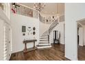 Grand entry with curved staircase, hardwood floors, and decorative accents at 6017 Merchant Pl, Parker, CO 80134