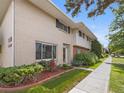 Two-story townhouse with well-maintained lawn, tidy shrubbery, and pedestrian sidewalk at 3981 S Boston St, Denver, CO 80237