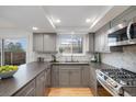 Updated kitchen featuring gray cabinets, modern appliances, and sleek countertops at 3981 S Boston St, Denver, CO 80237