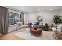 Bright living room with a large window, wood floors, and cozy contemporary furniture at 3981 S Boston St, Denver, CO 80237