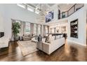 Bright and airy living room boasting high ceilings and seamless transition into the kitchen at 8017 S Valleyhead Way, Aurora, CO 80016