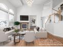 Bright, staged living room boasts hardwood floors, fireplace, and large windows, creating an inviting and airy atmosphere at 1445 Colebrook Ct, Castle Rock, CO 80109