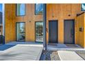 Modern home exterior highlighting sleek black entry doors, wood siding, and contemporary design details at 3829 Osage St, Denver, CO 80211