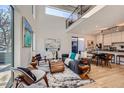 Bright, open-concept living area featuring hardwood floors, modern furnishings, and a stylish staircase at 3829 Osage St, Denver, CO 80211
