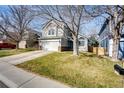 Beautiful two-story home featuring a lush lawn, a two-car garage, and a charming entrance at 11335 Haswell Dr, Parker, CO 80134