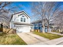 View of the home's front exterior featuring the garage, landscaping, and architectural details at 11335 Haswell Dr, Parker, CO 80134