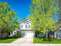 Beautifully landscaped home with mature trees, a two-car garage, and a well-maintained front yard at 11335 Haswell Dr, Parker, CO 80134