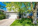 Inviting two-story home with lush green lawn, mature trees, and a convenient two-car attached garage at 11335 Haswell Dr, Parker, CO 80134