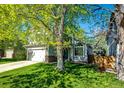 Beautiful home featuring a well-kept lawn, mature trees, and a welcoming front entrance at 11335 Haswell Dr, Parker, CO 80134