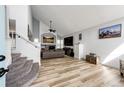 Spacious living room with a fireplace, vaulted ceilings, and modern flooring at 11335 Haswell Dr, Parker, CO 80134