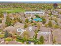 Aerial view showcasing the community amenities, including the pool, tennis courts, and nearby parking at 5872 W Asbury Pl, Lakewood, CO 80227