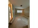 A light-filled bedroom with neutral walls, carpet, and a window with blinds at 1364 Iola St, Aurora, CO 80010