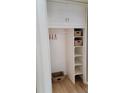 Closet with storage featuring open shelves with wicker baskets and a hanger rod at 1364 Iola St, Aurora, CO 80010