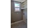 A charming laundry room with utility sink, shelving, and connections for a washer and dryer at 1364 Iola St, Aurora, CO 80010