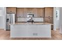 Spacious kitchen featuring large island with granite countertop and stainless steel appliances at 3318 N Haleyville Ct, Aurora, CO 80019