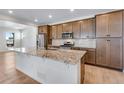 Modern kitchen showcasing granite countertops, stainless steel appliances, and ample cabinetry at 3318 N Haleyville Ct, Aurora, CO 80019
