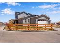 View of rear exterior featuring a fenced yard and attached two-car garage at 3318 N Haleyville Ct, Aurora, CO 80019