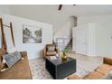 Bright living room featuring neutral walls, a ceiling fan, and a staircase to the upper level at 9544 Josephine St, Thornton, CO 80229