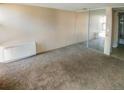 Spacious bedroom featuring neutral walls, carpet, and a closet with mirrored sliding doors at 2500 S York St # 213, Denver, CO 80210
