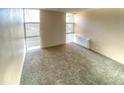 Bright room with large windows, carpet, and ample natural light at 2500 S York St # 213, Denver, CO 80210