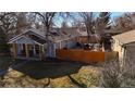 This well-manicured backyard includes a privacy fence, a deck, and a beautiful outdoor dining area at 6240 W 24Th Ave, Edgewater, CO 80214