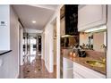 Hallway area featuring a mirrored wet bar, marble floors, and access to other rooms at 1900 E Girard Pl # 901, Englewood, CO 80113