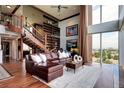 Cozy living room with a spiral staircase, floor-to-ceiling windows, and cityscape views at 1900 E Girard Pl # 901, Englewood, CO 80113