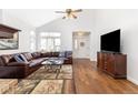 Inviting living room featuring high ceilings, large windows, hardwood floors, and a leather sectional at 2590 S Independence St, Lakewood, CO 80227