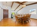 Inviting dining room with hardwood floors, wooden beams, large windows, and a spacious layout, perfect for gatherings at 3907 E 133Rd Ct, Thornton, CO 80241