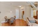 Cozy dining area with hardwood floors and a clear view into the kitchen and living area at 10111 Inverness Main St # 312, Englewood, CO 80112
